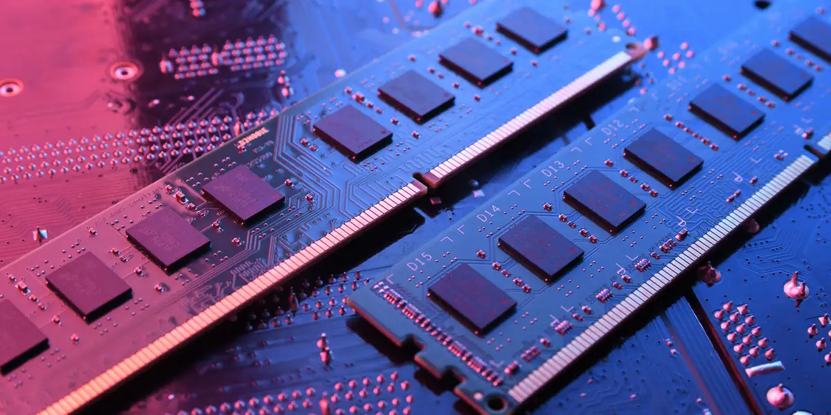 DDR5 memory modules on a PCB, lit in blue and red: bandwidth doubled at lower voltage compared with DDR4.